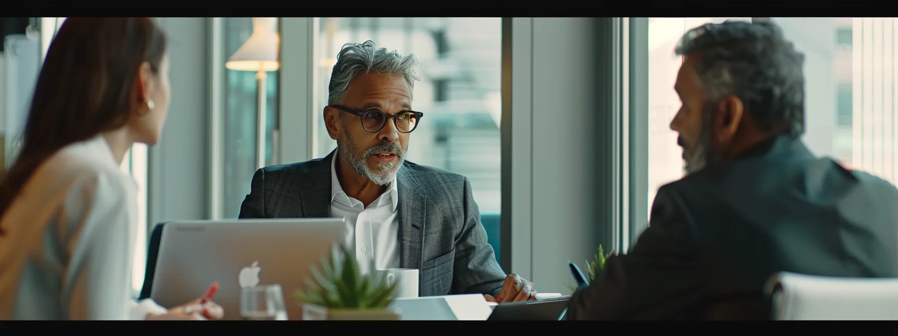 business executives discussing the impact of software solutions on revenue growth during a meeting in a modern office setting.